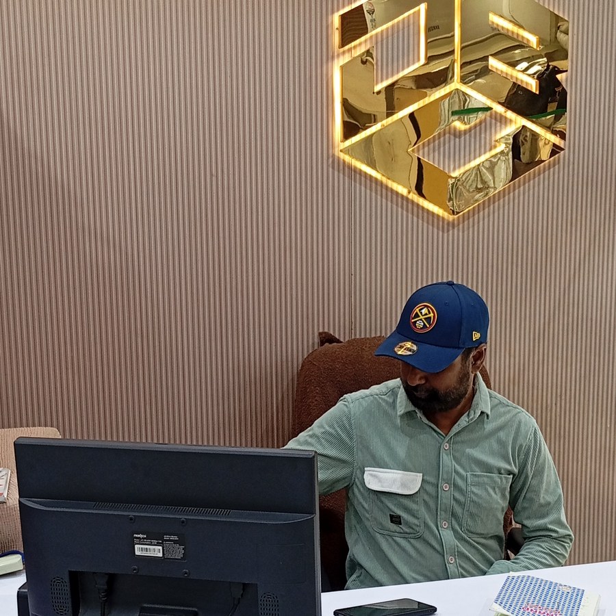 The boutique's gold cube logo mounted above the reception counter